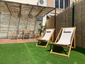 two lounge chairs and a table on a lawn at La Espiga de Segovia in La Lastrilla