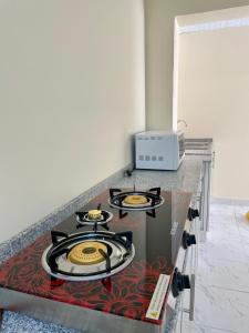 a kitchen with three burners on top of a counter at Abdullah Kamber Building in Dubai