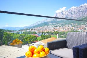 a bowl of oranges sitting on a table with a view at ATLANTIS LUX with pool in Makarska