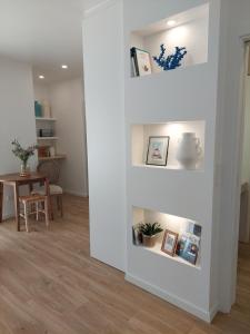 a living room with white walls and a table at Estúdio Lagoa Azul in Vila Nova de Milfontes +24 photos