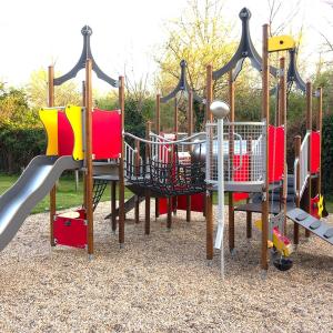 a playground with different types of playground equipment at Camping L'oasis Du Berry in Saint-Gaultier