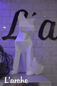 a purple sign with a paper cat with the word laureate at L'Arche Loft nid douillet - Spa privatif in Grenoble