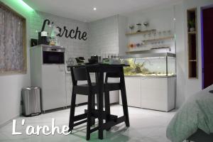 eine Küche mit einer Theke und einer Bar in einem Zimmer in der Unterkunft L'Arche Loft nid douillet - Spa privatif in Grenoble