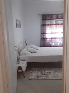 a bedroom with two beds and a window at Apricot garden in Kynopiástai