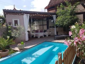 a swimming pool in the backyard of a house at Romantisches Rosencottage in Hofheim in Unterfranken