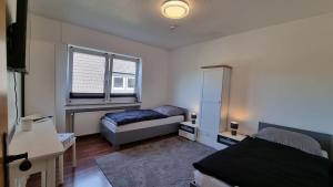 a small bedroom with a bed and a window at Bocholt Apartment Ferienwohnung 3 in Bocholt