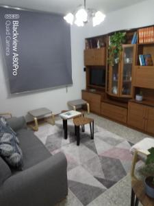 a living room with a couch and a chalkboard at A Niñada in Marín