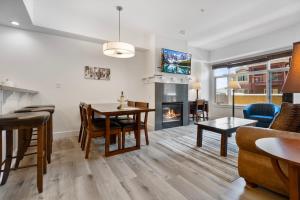 a living room with a dining table and a fireplace at Sundial Lodge 2 Bedroom by Canyons Village Rentals in Park City