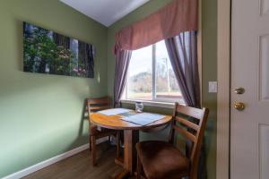 a table and chairs in a room with a window at Elk Meadow Cabins 9B Prairie Creek - Single Room in Orick