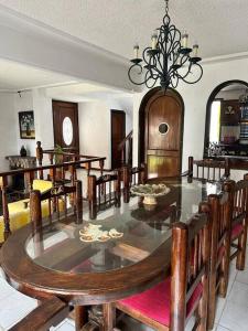 a dining room with a large table and chairs at Casa Estrella Oaxaca in Oaxaca City