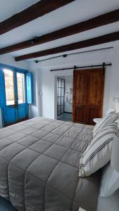 a large bedroom with a large bed in a room at La Botica de 1852 Hotel in Chascomús