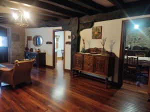 a living room with wooden floors and a wooden dresser at Hermoso Caserío Navarra. (Madoz) 