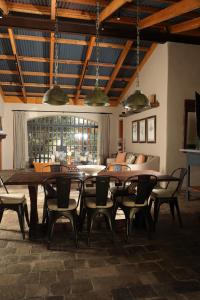 a dining room with a table and chairs and a couch at Alma Liebre Viñedos del Valle in Valle de Guadalupe