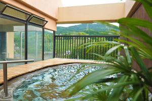 a swimming pool in the middle of a balcony at Koyokaku in Ureshino