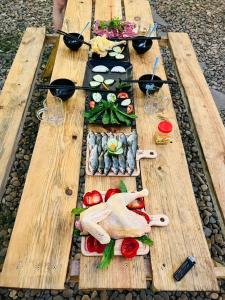a wooden table with different types of food on it at Retro Khe Sanh in Lao Bao