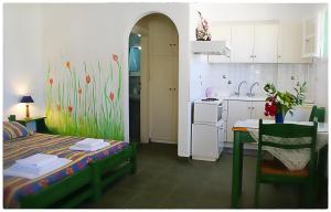 a kitchen with a bed and a table in a room at Georgios Milos in Adamas