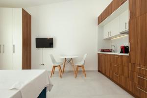 a room with a bed and a table and chairs at Barba Apartments in Ulcinj