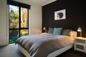 a bedroom with a large bed and a large window at Ablac House in Glenlyon