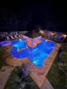 a swimming pool at night with a gazebo at Hotel Boutique Family Suites in Panguipulli