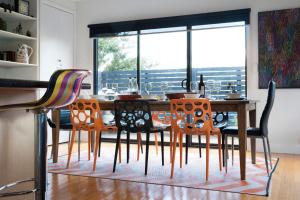 a dining room with a wooden table and chairs at Absolute in Daylesford