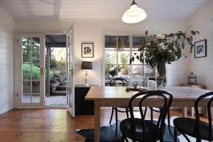a dining room with a wooden table and chairs at Albion in Daylesford