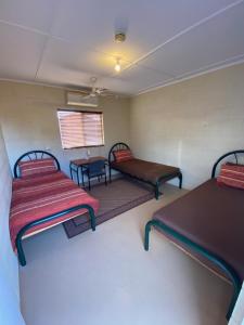 a small room with two beds and a table at Bendleby Ranges in Belton