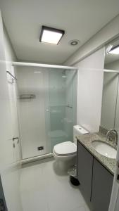uma casa de banho com um chuveiro, um WC e um lavatório. em Studio LifeSpace Batel Curitiba em Curitiba