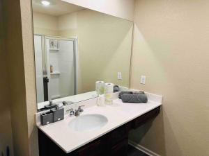 a bathroom with a sink and a large mirror at Modern Retreat near Hartsfield-Jackson Airport in Atlanta