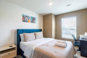 a bedroom with a bed and a desk and a window at Modern Retreat near Hartsfield-Jackson Airport in Atlanta