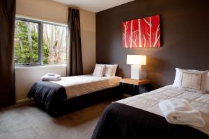 a hotel room with two beds and a window at Amici in Daylesford