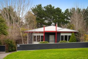 a red and white house with a fence at Amici in Daylesford