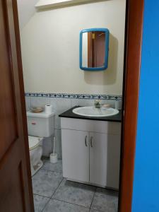 a bathroom with a sink and a mirror on the wall at Suite Magy-Manta in Manta