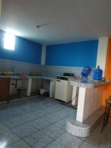 a kitchen with blue walls and a counter in a room at Suite Magy-Manta in Manta