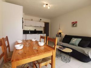 sala de estar con mesa de madera y sofá en Appartement Carnac, 2 pièces, 4 personnes - FR-1-477-236 en Carnac