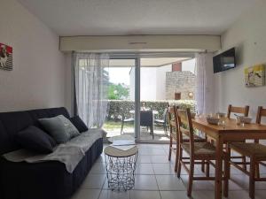 een woonkamer met een bank en een eettafel bij Appartement Carnac, 2 pièces, 4 personnes - FR-1-477-236 in Carnac