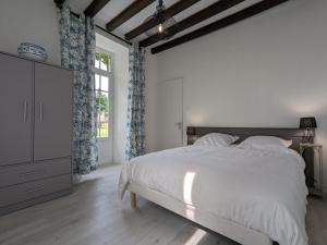 a white bedroom with a bed and a window at Gîte familial avec piscine couverte, jardin privé, proche d'Aubeterre-sur-Dronne - FR-1-653-239 in Bellon +27 photos