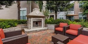 a patio with two chairs and a fireplace at Heart of NRG and Medical Center in Houston