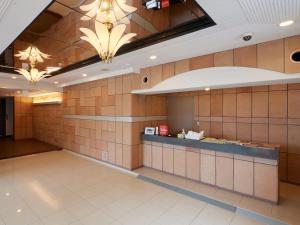 a waiting room with brown tile walls and a counter at Chateraise Lodge Atami in Atami