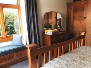 a bedroom with a bed and a window at 1920s Stay in Whanganui in Whanganui