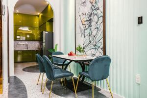 a dining room with a table and four chairs at Lamy House in Can Tho