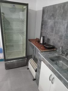 a bathroom with a shower and a sink and a counter at Alojamiento Mana in Malargüe