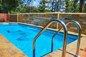 a swimming pool with a water fountain at Jabulani Private Villas in Arusha