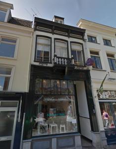 a store front of a building with a window at De Bronzen Koets in Nijmegen