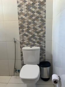 a bathroom with a toilet and a trash can at Canto da Gaivota Lençóis Maranhenses in Santo Amaro +14 photos