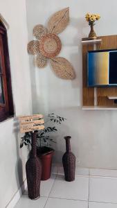 three vases sitting on the floor in a room at Canto da Gaivota Lençóis Maranhenses in Santo Amaro