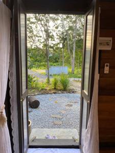 an open door with a view of a yard at Kebun Lisdtari farmstay in Air Hangat