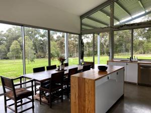 a kitchen and dining room with a table and chairs at Isle of Kilcarnup in Margaret River Town