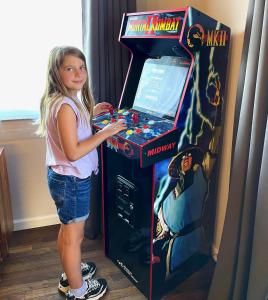 a little girl playing a video game in a video game arcade at Fishing bungalow on the water w/private dock in Clearlake