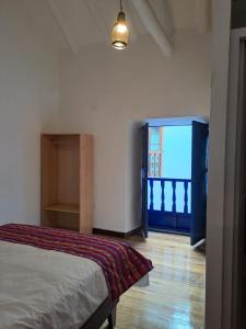 a bedroom with a bed and a large window at Marina's House Cusco Centro in Cusco