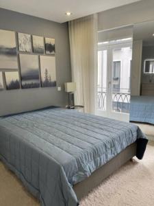 a bedroom with a large bed and a balcony at Modern 1 Bedroom City Center Aveiro Apartment in Aveiro